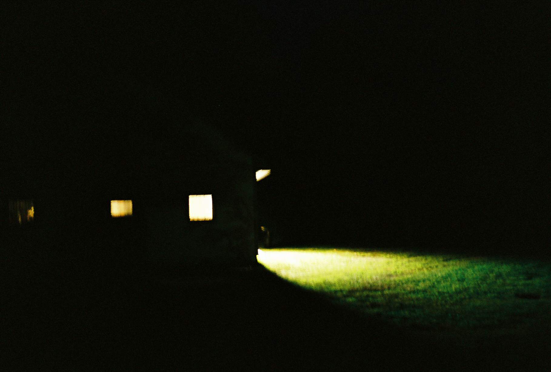 The location house at night — lit windows